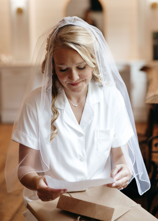 Bride reading note from husband on day of wedding